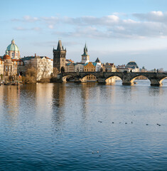 view of Charles Bridge and the Vltava River in the center of Prague before sunset