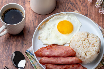Hamsilog (flatlay)- famous Filipino meal that consists of fried rice, egg and ham slices.