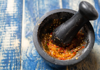 Malaysian hot dipping sauce in stone mortar. Selective focus. - 419032767