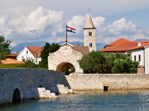 Nin, historic medieval town in the Zadar County of Croatia. Entrance gate and stone bridge that leads to city center. Nin is on the island on lagoon on the Adriatic Sea.
