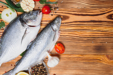 Raw dorado and trout fish with spices cooking on cutting board. Fresh fish dorado