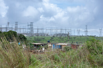 Precarious houses near electric power towers in Anapolis, Goias, Brazil