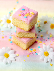 Stacked cakes with pink icing and sprinkles