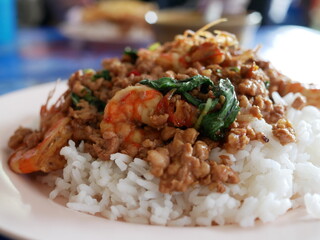 rice topped with stir fried pork and shrimp and basil.