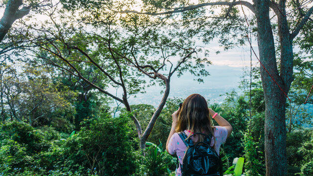 Young girl enjoying a beautiful view and taking photos in Merendon San Pedro Sula Honduras
