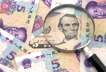 US dollar against china yuan and a magnifier