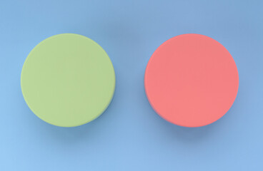 Two colored volumetric circles. Color - Sprout, Hue Green and Sea Pink, Hue Red. Background color - Portage, Hue Blue. Comparison concept, buttons, capacities.