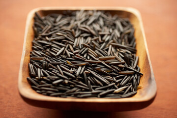 Black forbidden rice in a wooden bowl