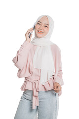 Beautiful young muslim woman smile while making a phone call over white background