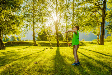 young boy playing in badminton outdoors
