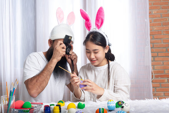 couple painting Easter eggs on Easter