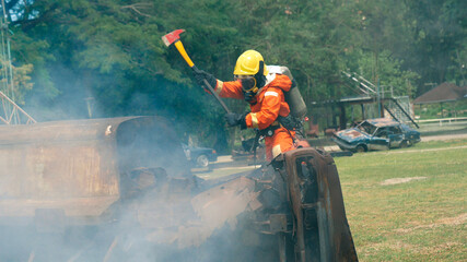 Firefighter fighting with flame using fire hose chemical water foam spray engine. Fireman wear hard...