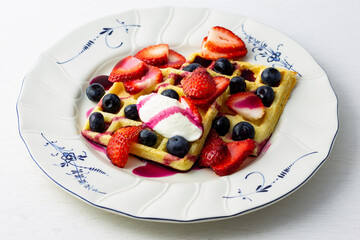 Waffles, strawberries, blueberries with yogurt