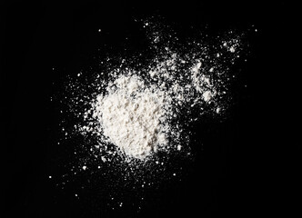 White flour sprinkled on a black table