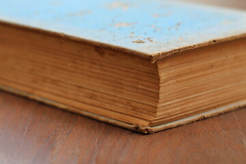 Naklejka na ściany i meble Really old book on wooden floor