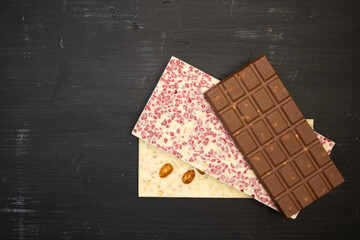 some sweet and tasty different chocolate bars an black background