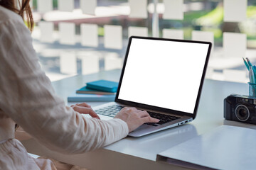 Mock up. Woman hand printing jobs using a laptop keyboard at the office.