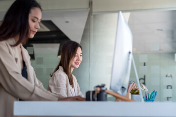 Fototapeta premium Image of a young Asian businesswoman sitting working at a modern office.