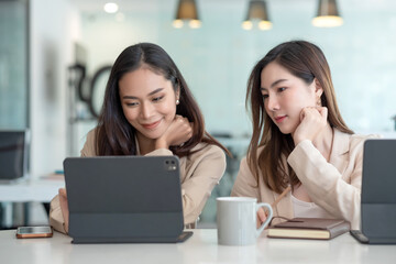 Young Asian businesswoman work together to analysis from work at the office.