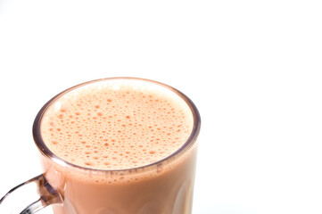 Close up view of tea with milk in a mug isolated on a white background. Selective focus.