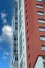 Fragment of the upper part of the facade of a residential building against the blue sky