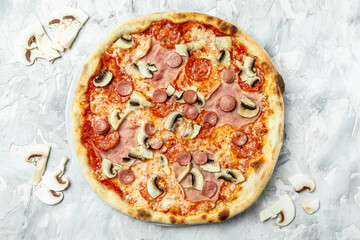 Capriciosa. Classic pizza with ham and mushrooms on a light background, top view. Traditional Italian pizza