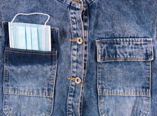 Collage with medical facemask in pocket of blue men’s shirt, closeup. Flat lay, upper view.  Protection coronavirus concept