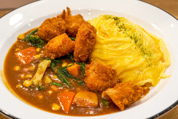 A tempting and delicious Japanese curry fried chicken omelet rice