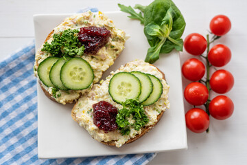 sandwich dip bread spread with salad vegetables on white porcelain plate 
