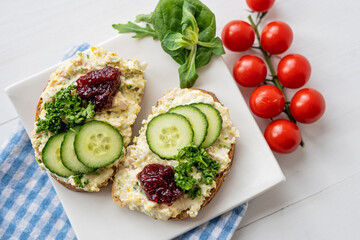 sandwich dip bread spread with salad vegetables on white porcelain plate 