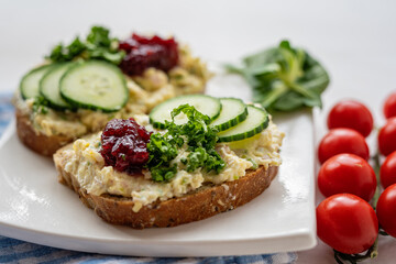 Fototapeta na wymiar sandwich dip bread spread with salad vegetables on white porcelain plate 