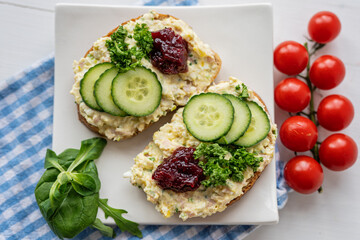 sandwich dip bread spread with salad vegetables on white porcelain plate 