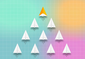 Group of paper planes in one direction on colorful background, Orange paper plane is leader. Leadership, teamwork and courage concept