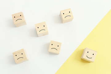 Concept image of satisfaction level. wooden cubes with emotions