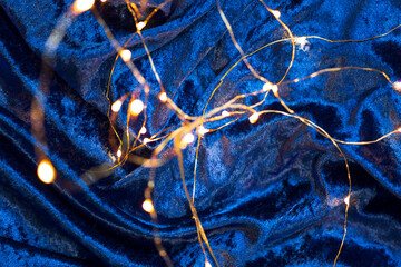 golden garland on blue velvet, festive texture, magical background