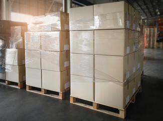 Stacked of Cardboard Boxes Wrapped Plastic on Pallet Rack. Interior of Storage Warehouse. Shipping Warehouse Logistics. Industry Cargo Export- Import.