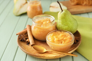 Tasty pear jam on wooden table