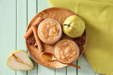Tasty pear jam on wooden table