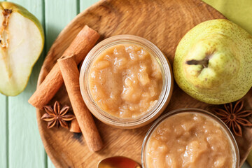 Jar with tasty pear jam on table