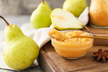 Bowl of tasty pear jam on table