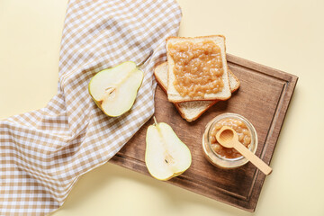 Jar of tasty pear jam with bread on color background