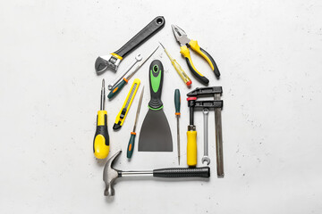 Composition with construction tools on light background