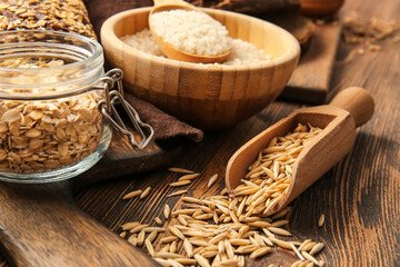 Different cereals on wooden background, closeup