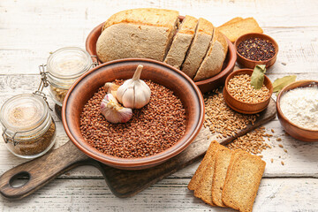 Set of different products on light wooden background