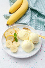 Plate with tasty banana ice-cream on light background