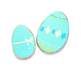 Tasty Easter cookies in shape of egg on white background
