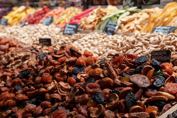 Market counter with various assorted dried fruits and nuts. Healthy food. Local market place.