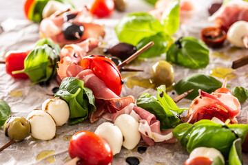 Caprese skewers italian or mediterranean appettizer tomatoes mozzarella olives and prosciutto