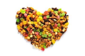 Heart shape made from various dry nuts and fruits, isolated on white. High-calorie vitamin mixture