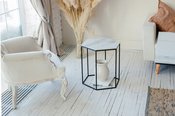 Stylish Scandinavian modern white cozy eco interior in minimalist style. Modern home decor with Pampas grass in vase. Open space. Monochrome, copy space